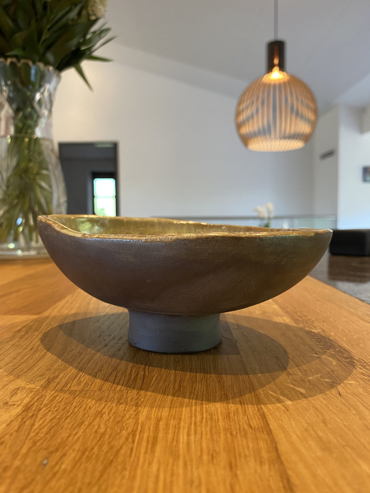 Skål Black Stone på fod med grøn glasur indvendig på spisebord – håndlavet keramik fra Keramikbyh