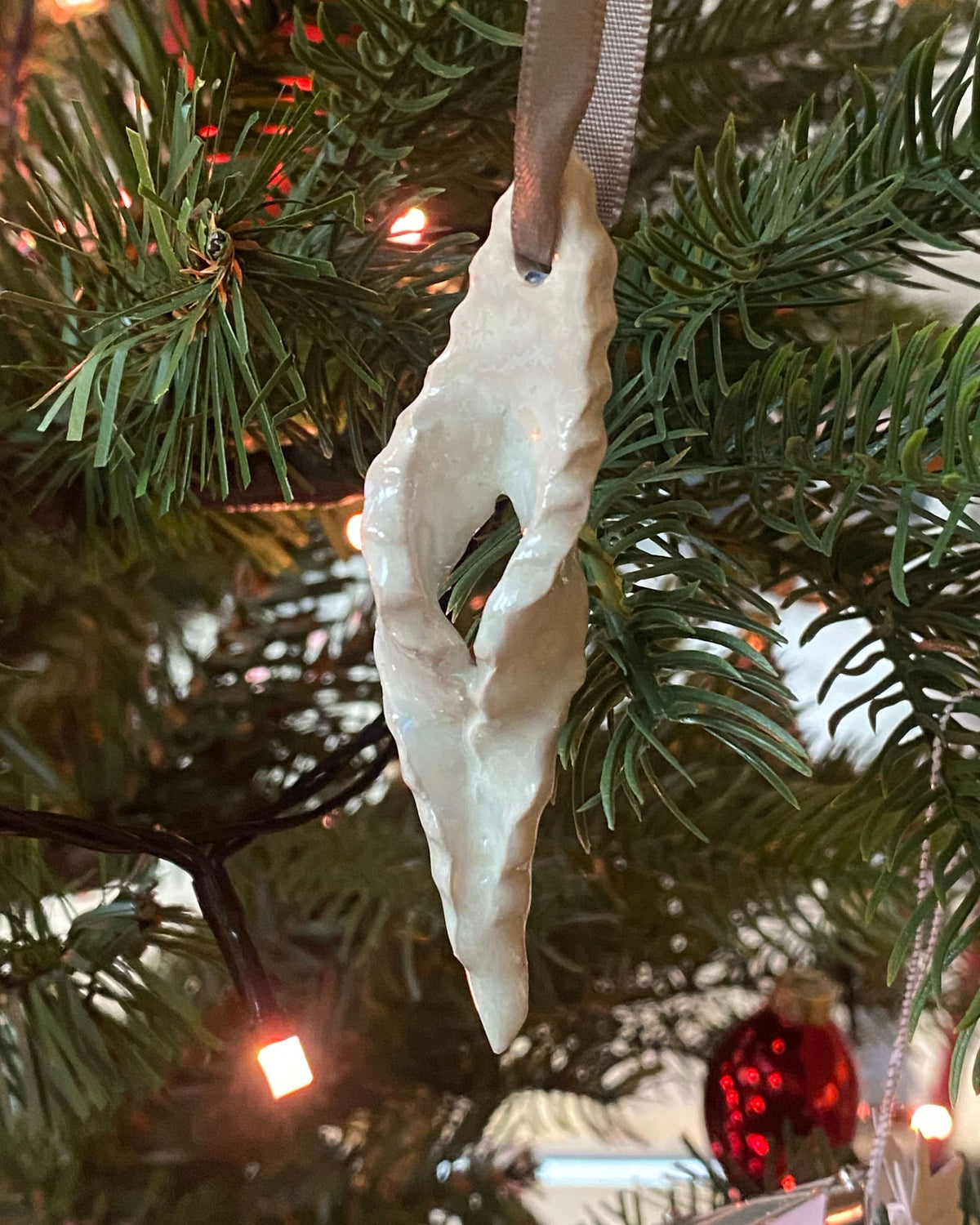 Klejne-ophæng i keramik med rødt bånd på juletræet